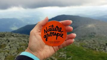 Nature Groupie Sticker held over scene of side of Mount Washington