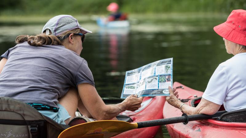 two kayakers looking at ID sheet
