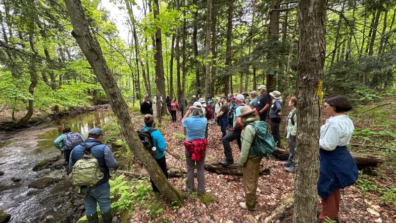 group standing by river bank