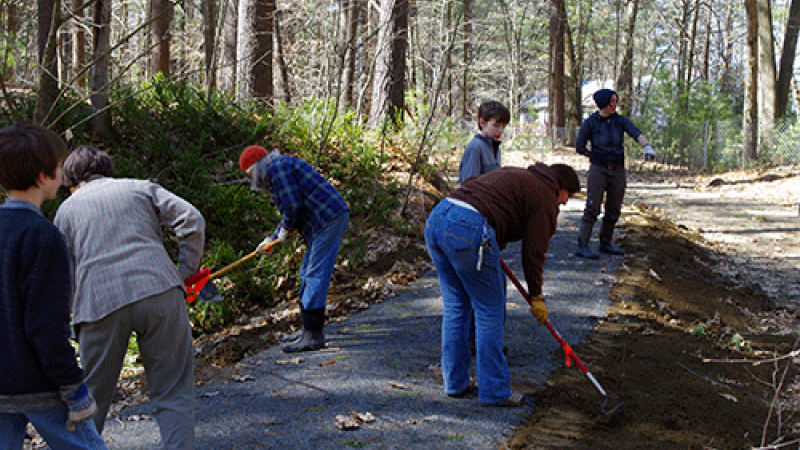volunteers raking a trail