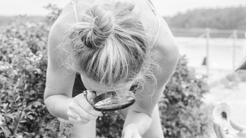 volunteer using a magnifying glass