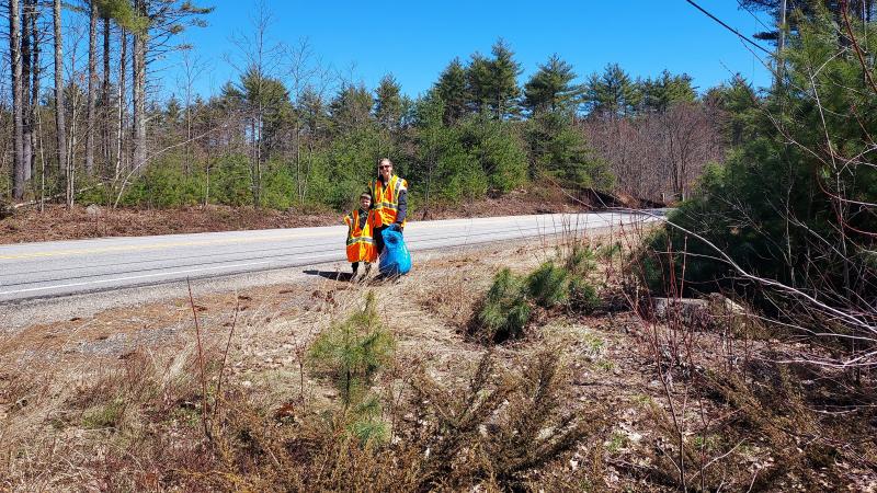 volunteers smiling standing along road