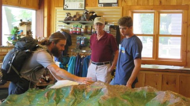 volunteer directing hikers over map