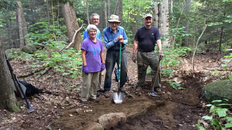 Volunteers holding a shovel