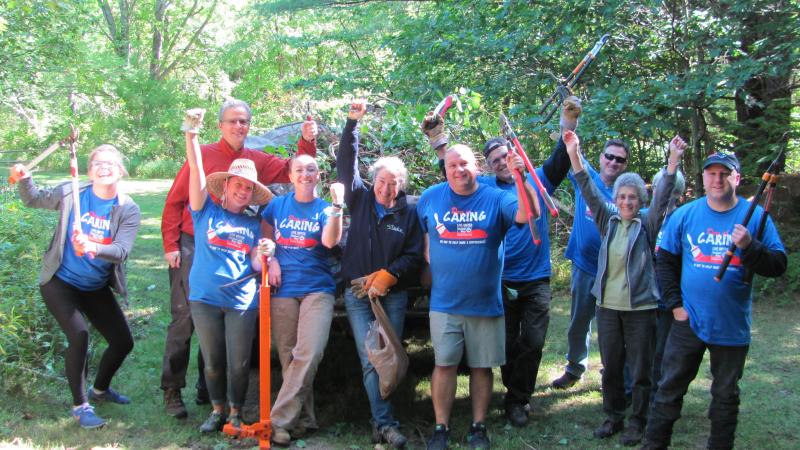 Group of volunteers holding tools