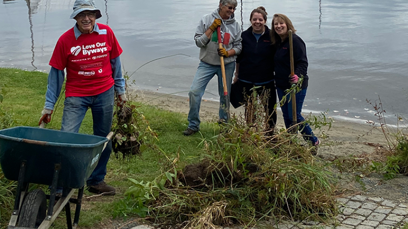 smiling volunteers near lake front