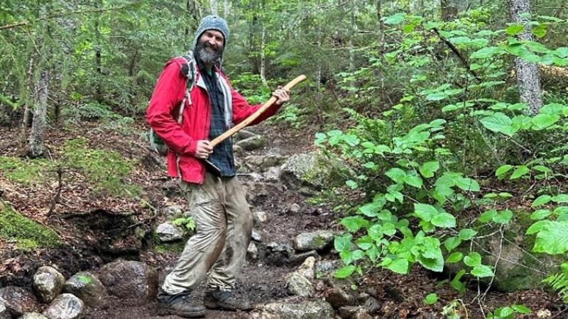 Volunteer on trail with ax
