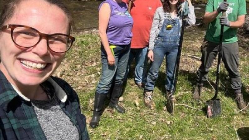 smiling volunteers near river