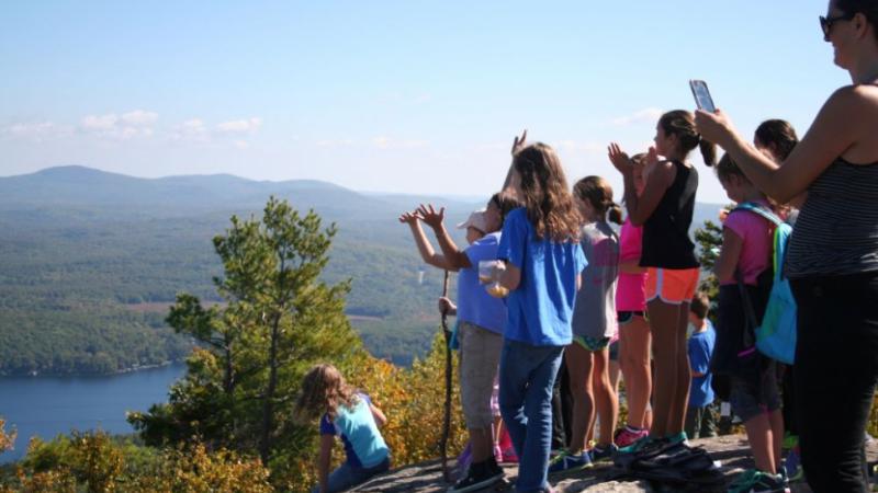 children on a mountain top looking at the view