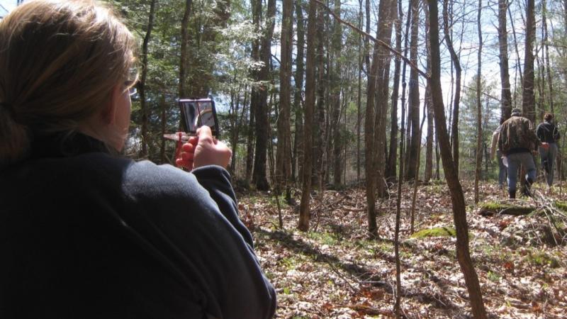 Volunteer looking through compass