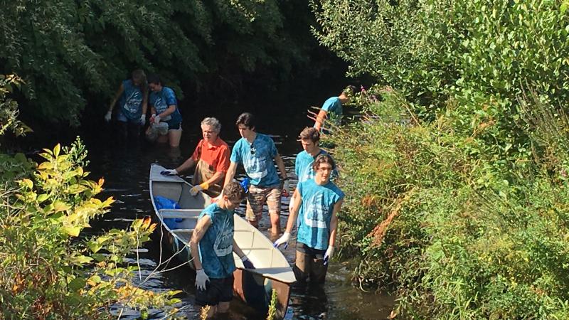 Volunteers on picking up trash along the river