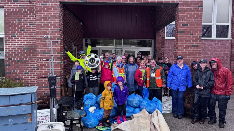smiling volunteers with trash