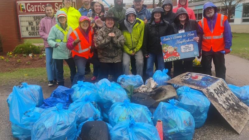 smiling volunteers with trash
