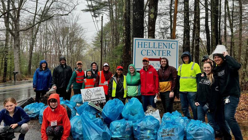 smiling volunteers with trash