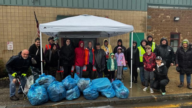 smiling volunteers with trash