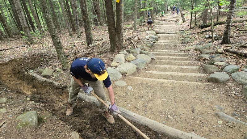 person clearing trail stair
