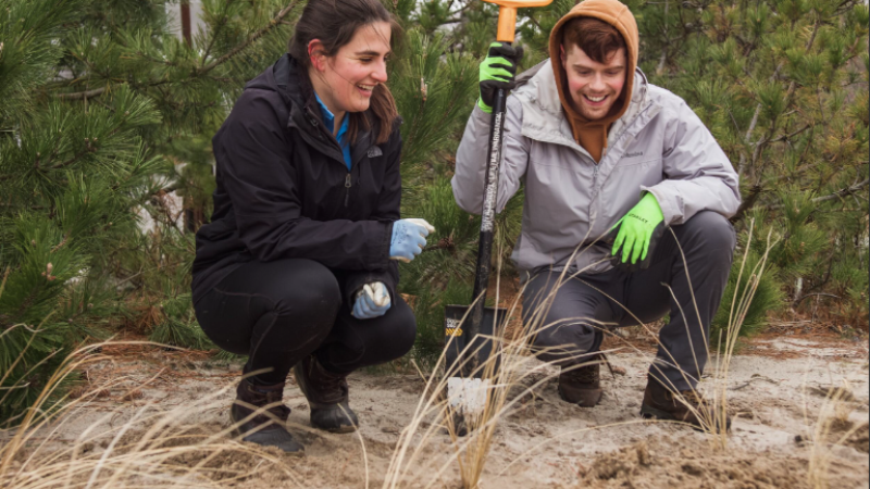 two people standing with shovel