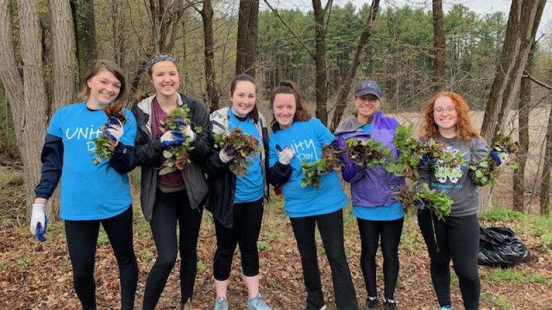 group of volunteers with pulled garlic mustard