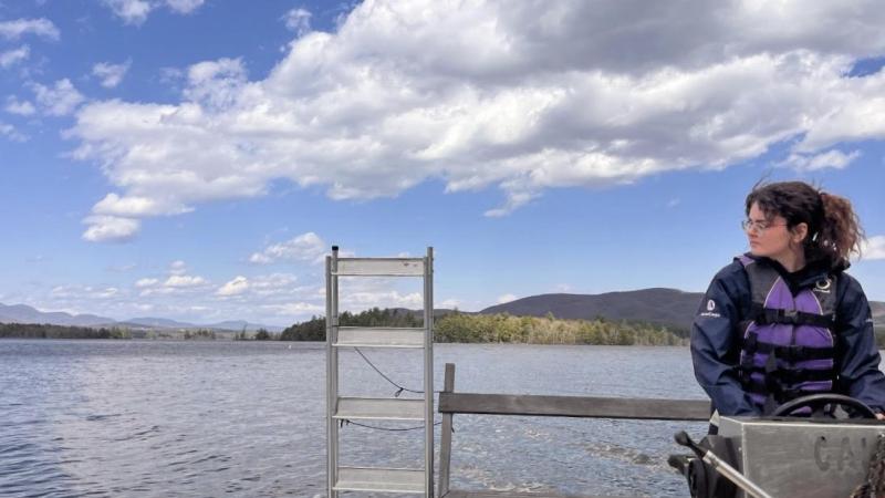 person driving a boat on lake