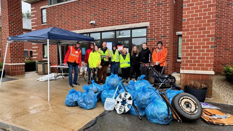smiling volunteers with trash