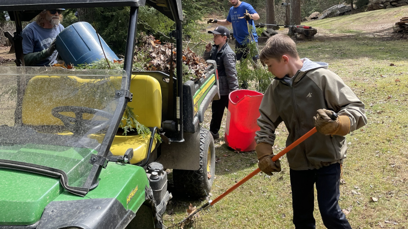 kids using rakes to clear debris