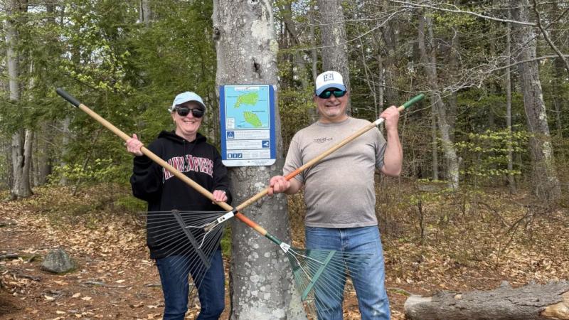 two volunteers holding tools