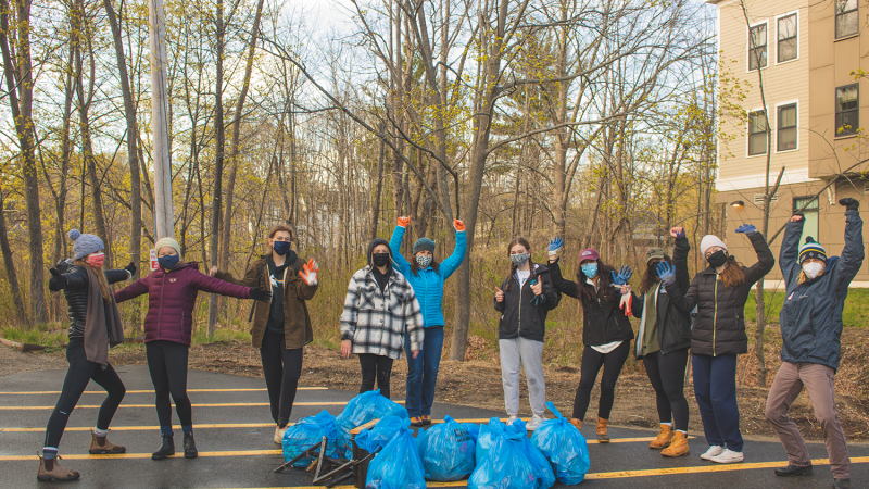 group smiling with trash