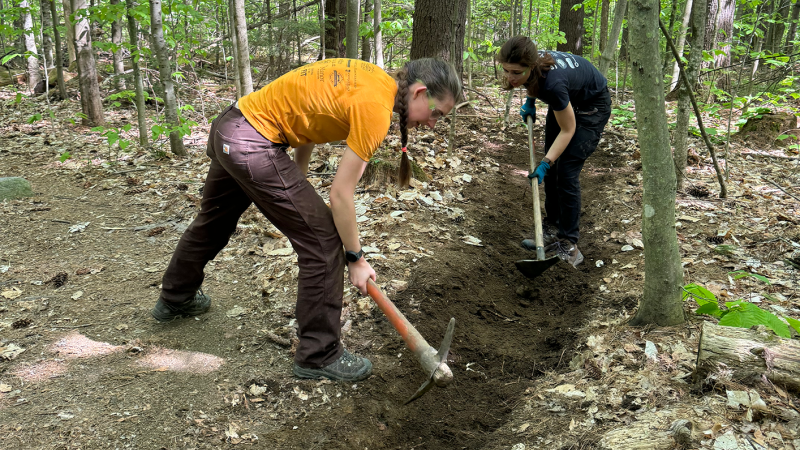 two volunteers doing trail work