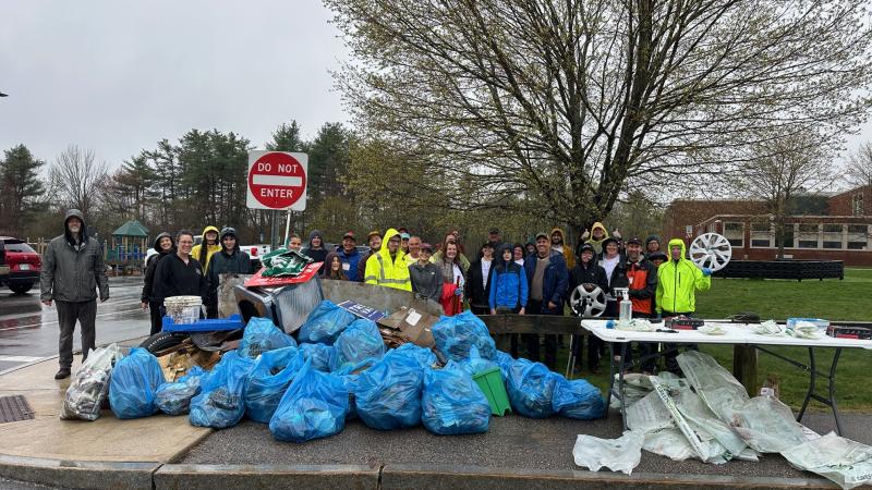 smiling volunteers with trash