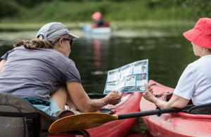 two kayakers looking at ID sheet