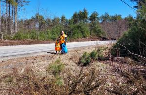 volunteers smiling standing along road