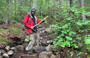 Volunteer on trail with ax