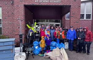 smiling volunteers with trash
