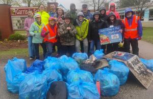 smiling volunteers with trash