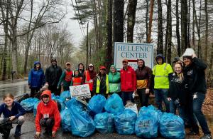 smiling volunteers with trash