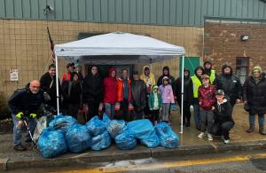 smiling volunteers with trash