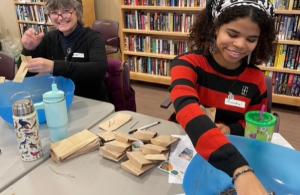 two volunteers packing seeds