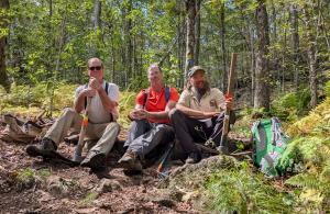 people smiling sitting on trail