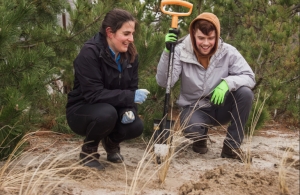 two people standing with shovel