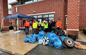 smiling volunteers with trash