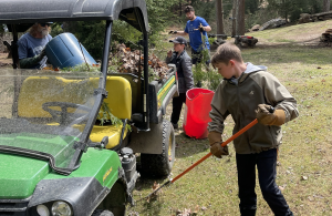 kids using rakes to clear debris