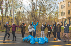 group smiling with trash