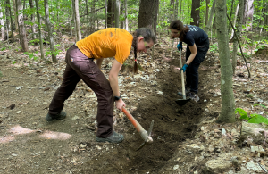 two volunteers doing trail work