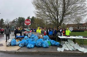 smiling volunteers with trash