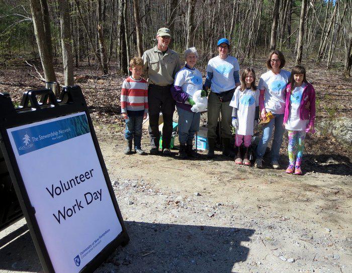 volunteers with a work day sign