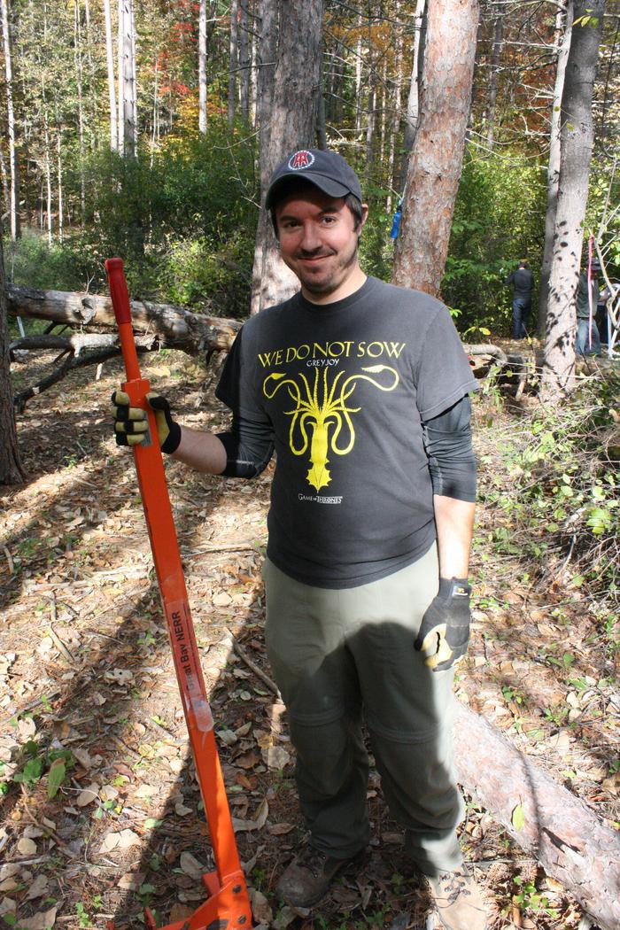 glossy buckthorn volunteer holding weed wench