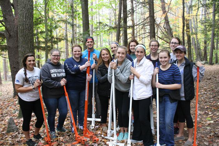 group of volunteers holding weed wenches