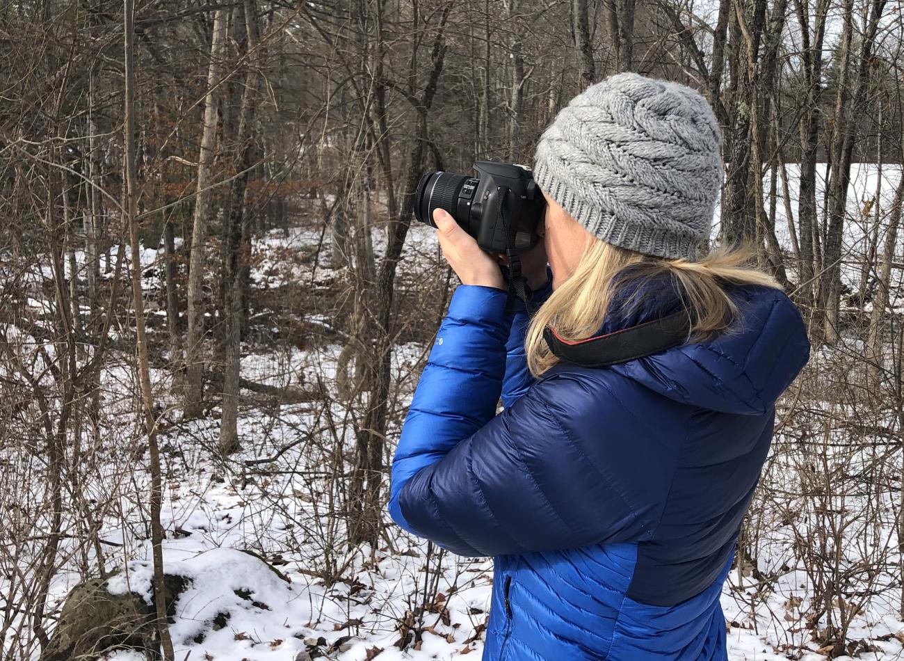 Person with camera in woods