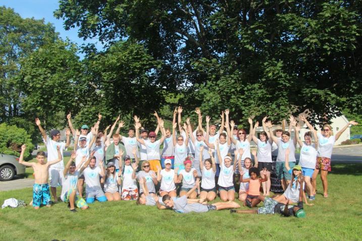 group of volunteers posing with hands in the air