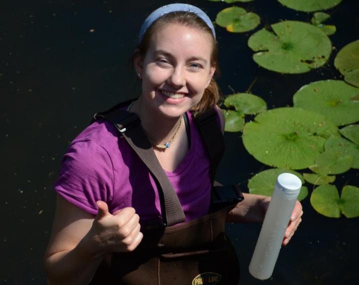 UNH sophomore Emily Balcom collects freshwater samples at the Bellamy River in Dover.